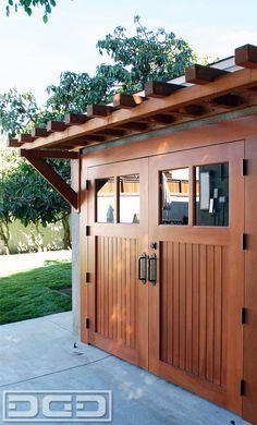 a wooden garage door with windows on the side