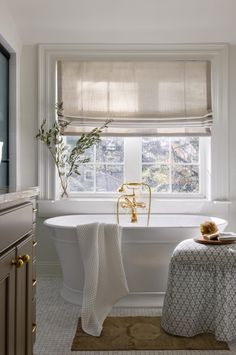 a white bath tub sitting next to a window