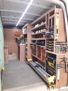 the inside of a garage with tools and equipment on shelves, including drillers, screwdrivers, hammers and other items