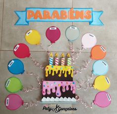 a birthday cake with candles and balloons on the floor in front of it that says parabiens