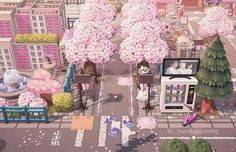 an aerial view of a city with pink flowers