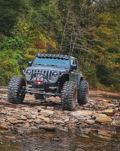 a jeep driving on rocks in the water