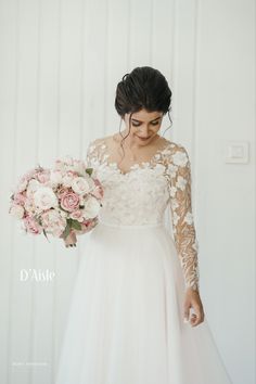 a woman in a wedding dress holding flowers