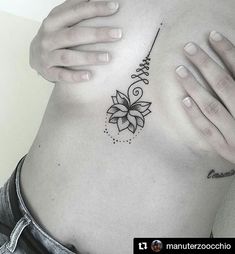 a woman's stomach with a flower tattoo on her belly and the word love written in cursive writing