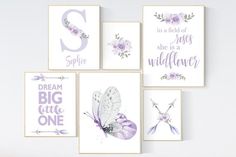 four purple and white wall hangings with flowers, butterflies, and the words dream big little one on them