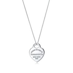 Inspired by the iconic key ring first introduced in 1969, the Return to Tiffany collection is a classic reinvented. This design's simple yet elegant aesthetic effortlessly exudes modern grace. Sterling silver; Heart tag, size medium; On an 18" chain | Return to Tiffany® Heart Tag Pendant in Silver, Medium, Size: 18 in. Tiffany & Co, Tiffany Key Ring, Return To Tiffany Necklace, Heart Necklace Tiffany, Tiffany Key, Tiffany And Co Necklace, Return To Tiffany, Tiffany Necklace, Sterling Silver Heart Pendant