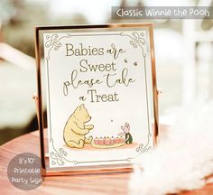 a winnie the pooh baby shower sign sitting on top of a table