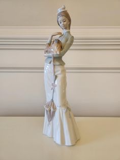 a ceramic figurine of a woman holding a baby