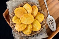 a basket filled with cut up cookies next to a spoon