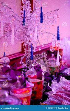 the table is covered with purple and white decorations, including candles, candy bars, and candies