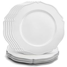 white dinner plates stacked on top of each other with scalloped edges and beading