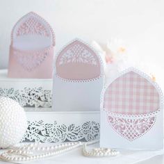 pink and white cards with lace on them