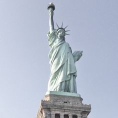 the statue of liberty is shown against a blue sky