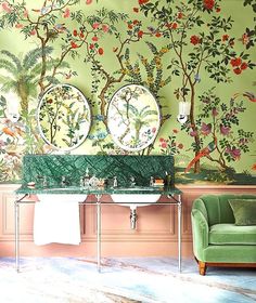 the bathroom is decorated in green and pink with floral wallpaper on the walls, along with two sinks