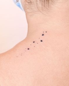 the back of a woman's neck with stars on it