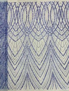 two blue and white beaded curtains with fringes on the sides, one in front of