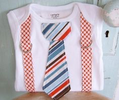 a white shirt with suspenders and a tie on top of a wooden stool in front of a blue wall