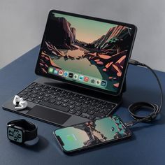 an open laptop computer sitting on top of a table next to headphones and ear buds