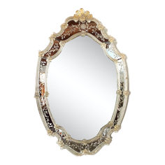 an ornately decorated mirror is shown against a white background