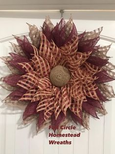 a wreath made out of burlocks and mesh on the front door with words, circle homestead wreaths