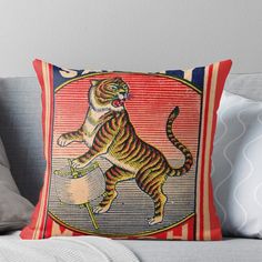 a tiger jumping over a bowl on top of a couch