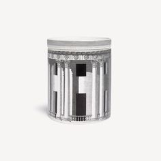 a silver and black candle holder on a white surface with columns in the middle,