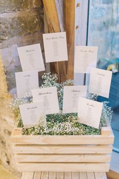 seating cards are placed in a wooden box