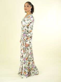 You'll instantly be in love! The Dalila floral print wrapped maxi dress fabric detail finish with high quality fabric. Ultra-chic dress with a surplice. Ruffle-trimmed high-low hem and has full closure. 59inch polyester hand-wash full lined Spring Flowy Faux Wrap Maxi Dress, Modest Fitted Floral Maxi Dress, Flowy Faux Wrap Dress For Spring, Modest Fitted V-neck Maxi Dress, White Floral Print V-neck Wrap Dress, Flowy Maxi Length Faux Wrap Dress, Fitted Maxi Dress With Floral Print And Surplice Neckline, Flowy Floral Maxi Dress With Surplice Neckline, Spring Floral Print Wrap Dress