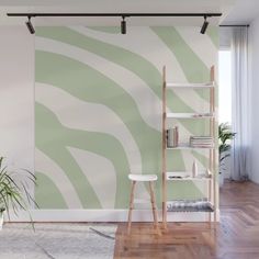 a green and white zebra print wall mural in a living room with wooden flooring