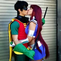 a man and woman are dressed up as princess peach and prince charming kiss each other in front of a garage door