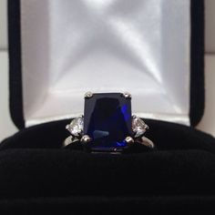 Beautiful Blue & White Sapphire Ring * 4.5ct Emerald Cut Blue Sapphire measures 10mm x 8mm * 3mm Brilliant Cut White Sapphire Accents * 5cts Total weight * Solid Sterling Silver * Sized to Order - Select Your Size Hallmarked & Gift Ready! Matching Earrings & Ring Also Available! These Sapphires are Laboratory Grown & are identical to natural in every way, including Chemistry, Composition & Hardness with Excellent Clarity & Color Refraction. TIMELESS, BEAUTIFUL & UNIQU Classic Cushion Cut Brilliant Gemstones, Classic Sapphire Gemstones With Brilliant Cut, Formal Blue Brilliant Cut Gemstones, Blue Brilliant Cut Gemstones For Formal Occasions, Elegant Cubic Zirconia Gemstones For Promise Ring, Classic Wedding Gemstones With Diamond Cut, Elegant Royal Blue Brilliant Cut Rings, Elegant Royal Blue Sapphire Ring With Center Stone, Classic Sapphire Gemstones For Anniversary