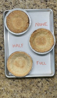 three pies sitting on top of a metal pan