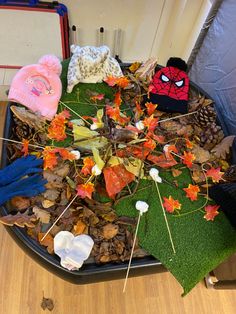 a pile of leaves and hats on top of a table