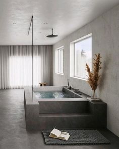 a bathroom with a large jacuzzi tub next to a window and a rug on the floor