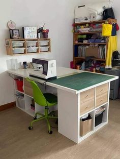 a desk with a computer on top of it in front of a book shelf filled with books