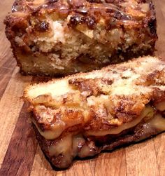 two pieces of bread sitting on top of a wooden cutting board