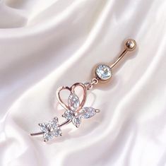 Super cute y2k 2000s rose gold diamond rhinestone butterfly heart dangling belly piercing ring bar.  Surgical steel  FREE STANDARD UK SHIPPING Dangle Metal Belly Rings, Elegant Body Jewelry With Bling For Gifts, Elegant Metal Dangle Belly Rings, Elegant Adjustable Dangle Belly Rings, Elegant Metal Belly Rings As Gift, Elegant Metal Belly Rings For Gift, Dainty Metal Body Jewelry As Gift, Dangle Body Jewelry For Gifts, Dangle Cubic Zirconia Body Jewelry As A Gift