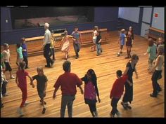 a group of people dancing on a wooden floor