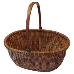 a brown wicker basket with leather handles