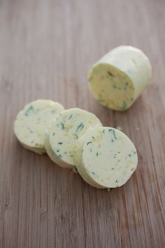 three pieces of cheese sitting on top of a wooden table