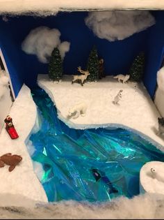 a fake snow scene with polar bears and other animals