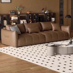 a living room filled with furniture and a book shelf on top of a hard wood floor