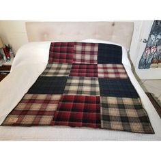 a bed with a plaid blanket on top of it