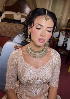 a woman in a wedding dress with jewelry on her head