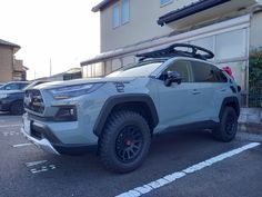 a white suv parked in front of a building