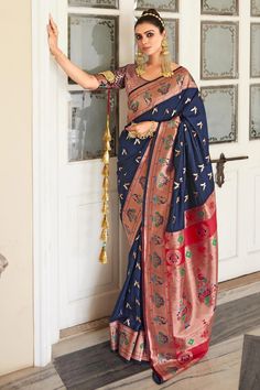 Turn heads in the captivating Navy Blue Paithani Silk Saree, a timeless embodiment of Indian tradition. This exquisite saree is adorned with delicate motifs, exuding an aura of refinement and grandeur. The intricately woven traditional Paithani Border and Pallu add a touch of opulence, lending a regal and ethereal look. Elevate your ethnic wardrobe and experience the joy of draping a saree that celebrates Indian elegance and femininity. Occasion: Wedding Wear, Party Wear, Festive Wear, Engagemen Maharashtrian Saree, Navy Blue Saree, Party Wear Traditional, Paithani Silk Saree, Blue Silk Saree, Wedding Blue, Half Sleeve Blouse, Blue Saree, Art Silk Sarees