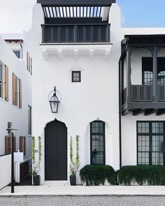 a white house with black shutters and windows