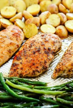 grilled chicken, potatoes and green beans on a baking sheet