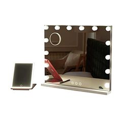 a vanity mirror with lights on it and a cell phone in front of the mirror