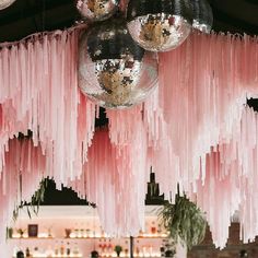 pink and black decorations hanging from the ceiling